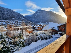 A snowy mountain village with wooden houses and a clear sky.