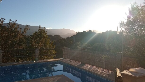 A swimming pool with a view of mountains in the background. - Villa Aurora El Gastor by Ruralidays (Cádiz)