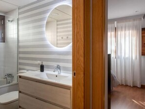 Bathtub, hair dryer, towels, soap