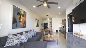 A modern living room with a sofa, coffee table, and artwork on the wall. - Endless,upscale four bedroom. (Cabo San Lucas)