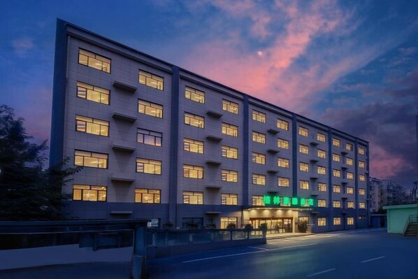 A multi-story hotel with a modern facade, large windows, and a visible entrance with signage. - GreenTree Inn (Suzhou Si County Luanhe Avenue) (Si County)