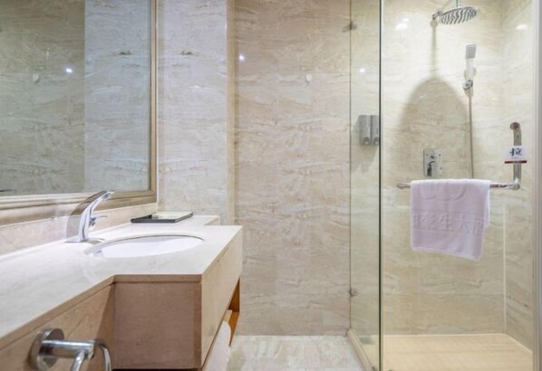 A bathroom with a marble sink, a glass shower enclosure, and a towel hanging on a rack. - Wanhe Haosheng Hotel (Lishui)