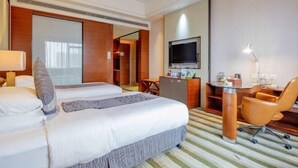 A hotel room with a large bed, a desk with a chair, a television, and a desk lamp. - Ruixiang International Hotel (Quanjiao)