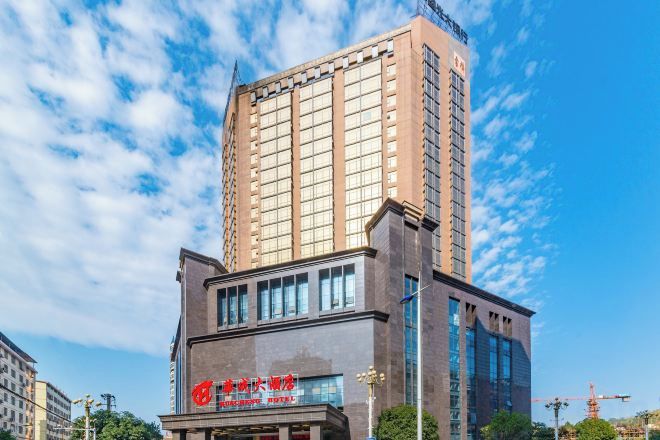 A multi-story hotel with a prominent sign and a modern facade.
