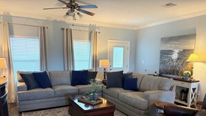 A living room with two sofas, a coffee table, a rug, and a ceiling fan. - Angler Sunrise..Luxury House on water (Hackberry)