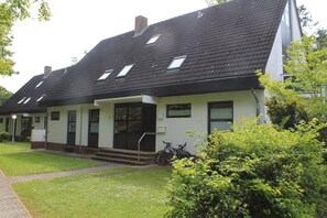 A single-story house with a sloped roof, a front porch, and a small front yard.