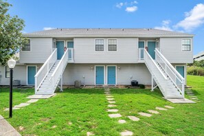 Stunning two-story home with a central staircase and beautifully manicured lawn.