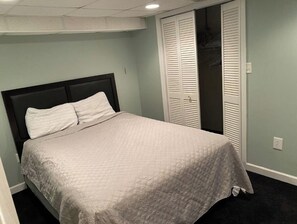 Cozy retreat with a single bed, closet, and carpeted floor.