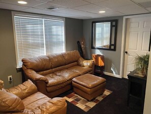 Relax in this inviting living space with a comfortable sofa, matching ottoman, and a side table.