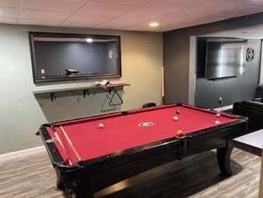 Enjoy a game of pool in our billiards room, featuring a pool table and mounted TV.