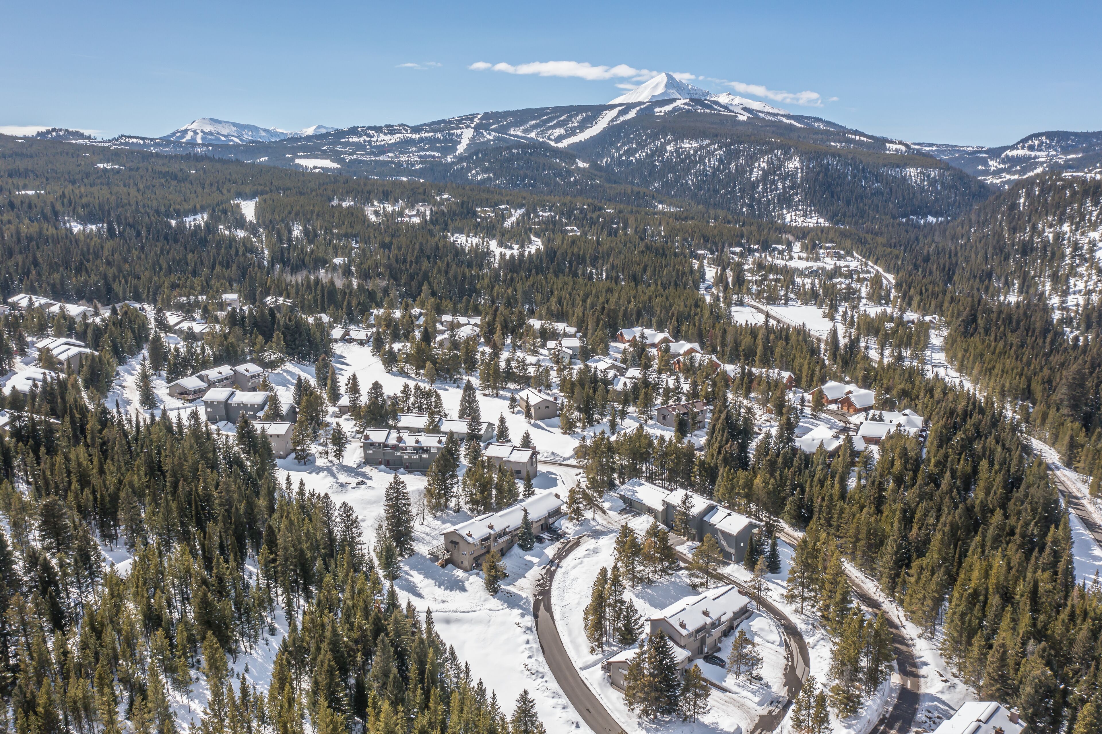 See the snowy Hidden Village neighborhood with Big Sky's peaks on the skyline | Exterior