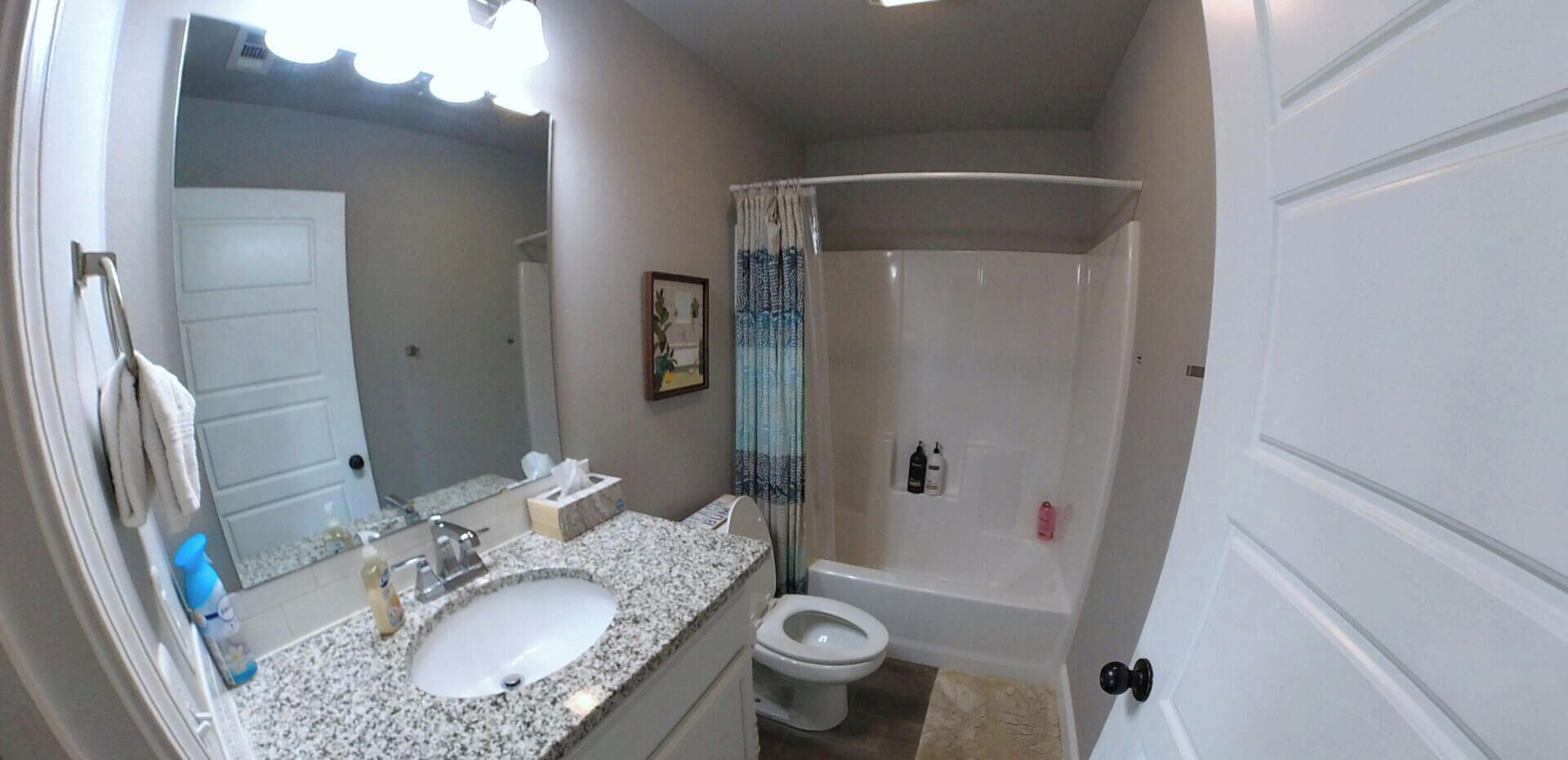 A bathroom with a sink, toilet, and shower.