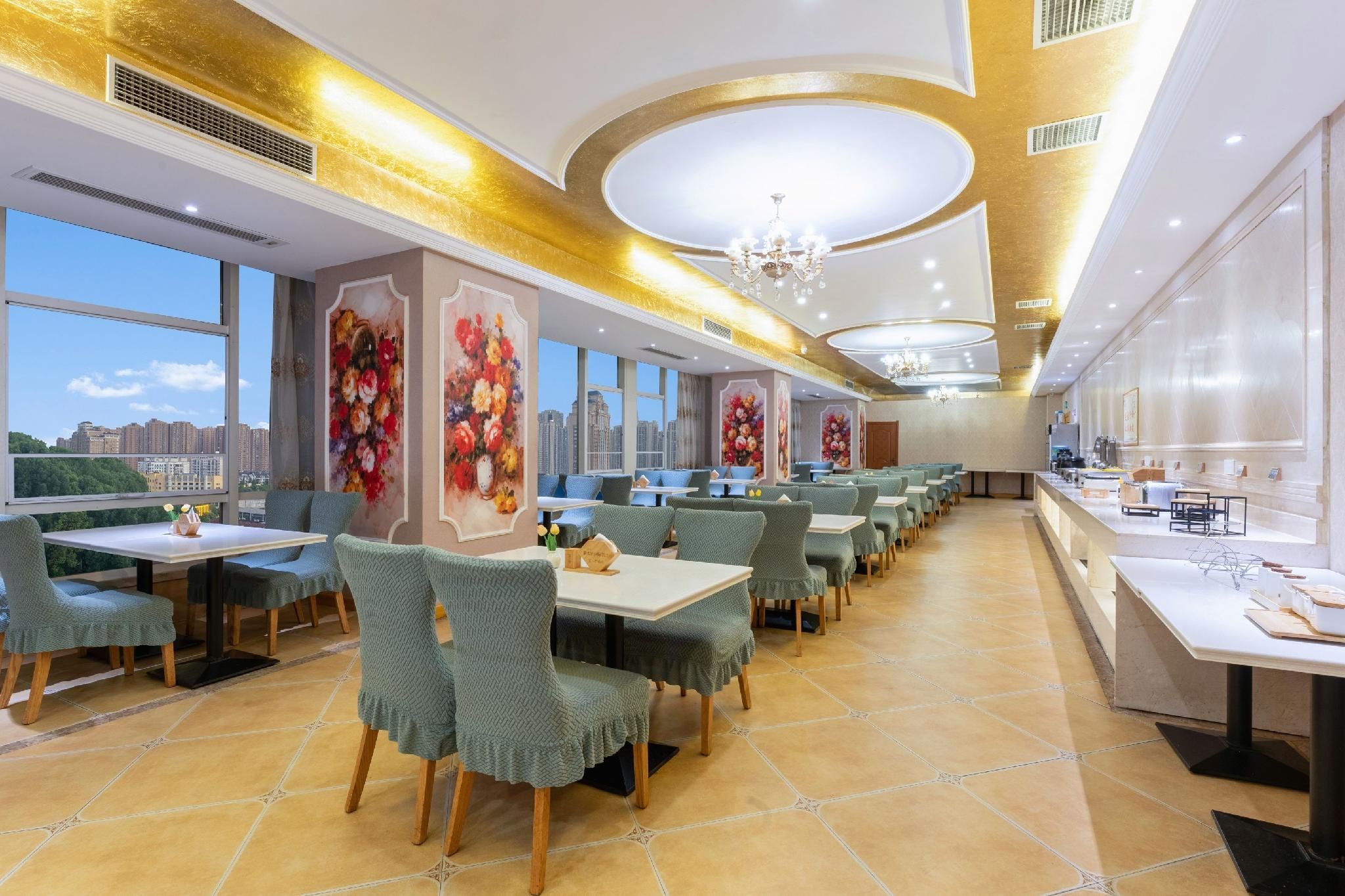 A restaurant with multiple tables and chairs, large windows, and a city view.