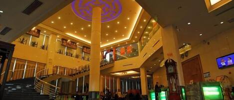 A spacious indoor area with a central column, multiple levels, and a staircase.