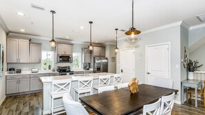 A modern kitchen with white cabinetry, stainless steel appliances, and pendant lighting. - Closest Complex to Community Pool | Electric Car Charging Outlet | Private Beach Club | Golf |Tennis (Pensacola)