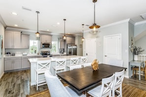 A modern kitchen with white cabinetry, stainless steel appliances, and pendant lighting. - Closest Complex to Community Pool | Electric Car Charging Outlet | Private Beach Club | Golf |Tennis (Pensacola)