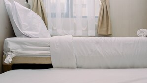 A neatly made bed with white linens and a rolled towel on the side. - Best Deal And Comfy 2Br At Kebagusan City Apartment (Jakarta)