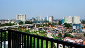 A cityscape with high-rise buildings, a bridge, and a mix of commercial and residential structures. - Comfy 2Bedroom At Signature Park Grande Apartment (Jakarta)
