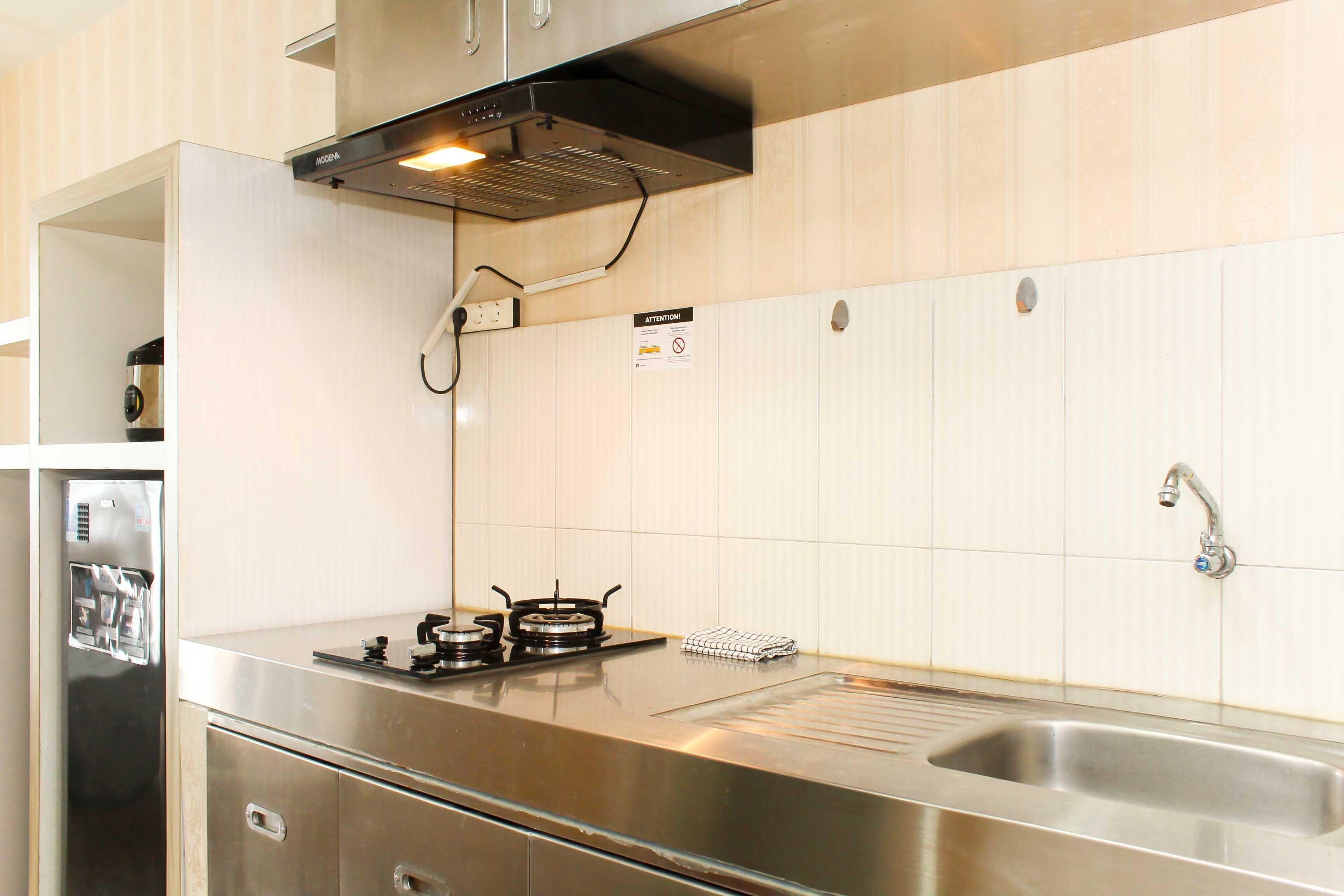 A kitchen with stainless steel appliances, a gas stove, and a sink.