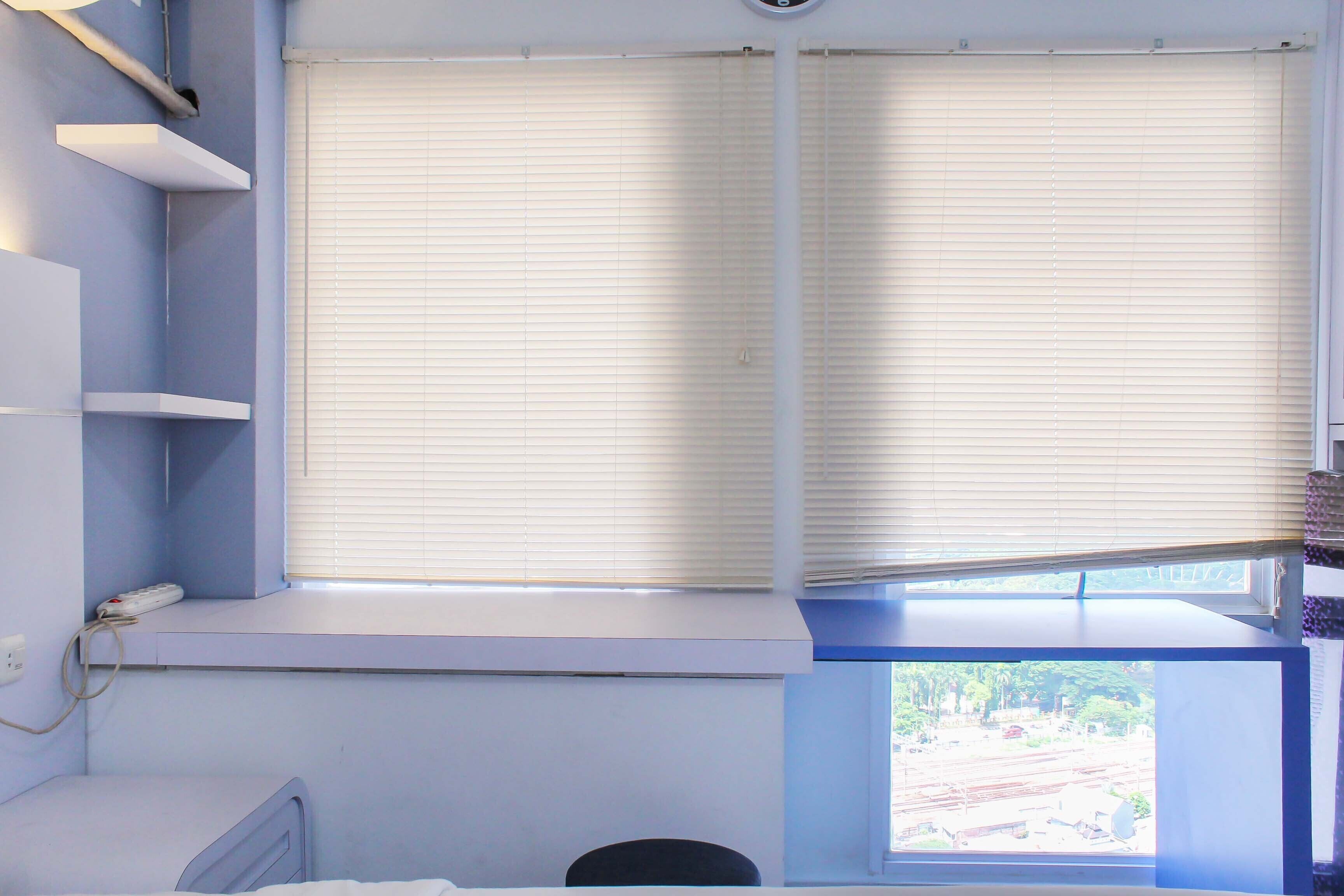 A room with a window, a radiator, and a small table.