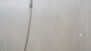 A shower with a handheld showerhead and a handheld hose. - Comfort Living Studio Room At Serpong Garden Apartment (Cisauk)