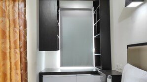 A compact bathroom with a mirror, vanity, and a toilet.