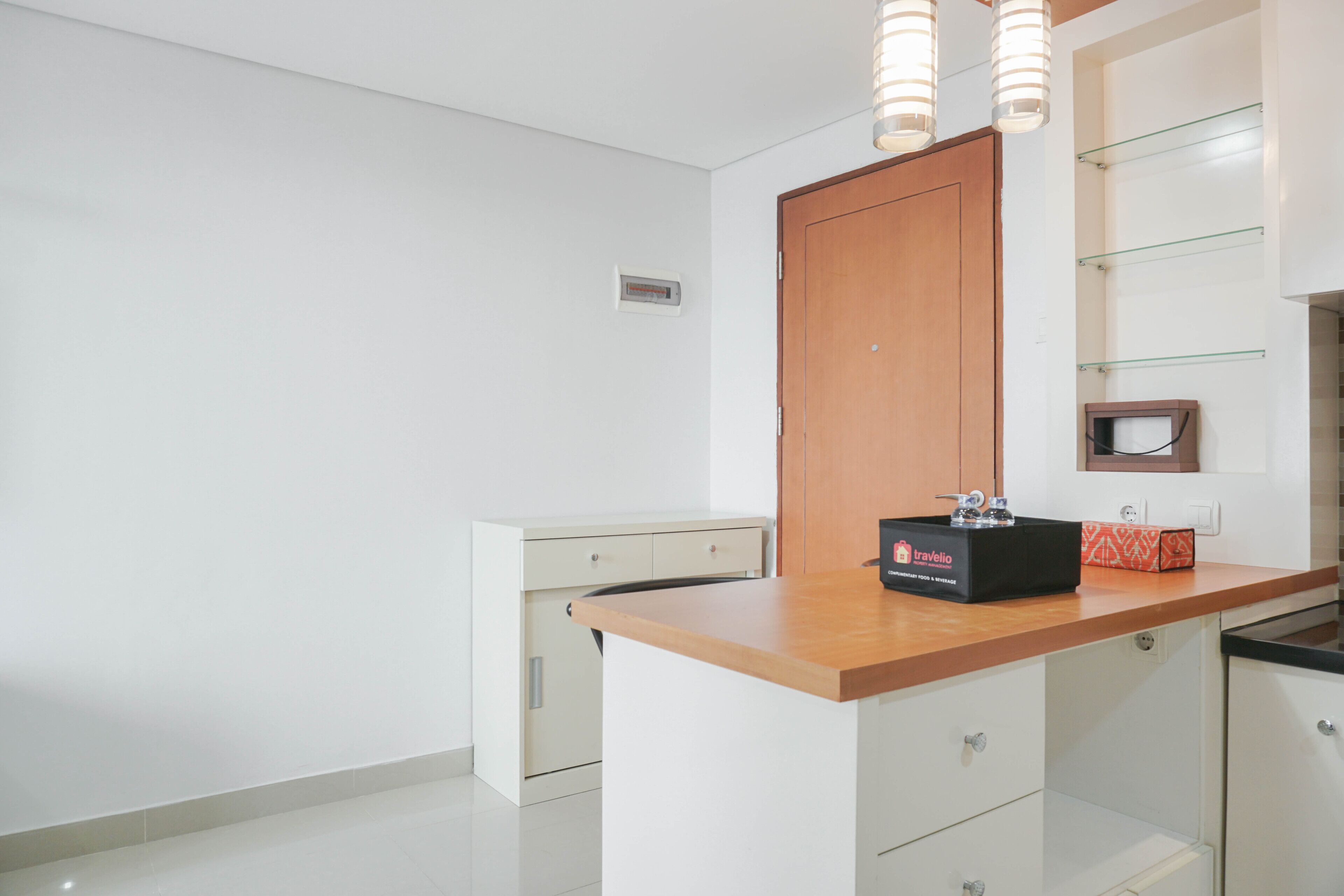 A modern kitchen with a wooden countertop, white cabinetry, and a built-in oven.