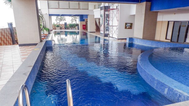 An indoor swimming pool with clear water, a tiled deck, and a metal ladder. - Cozy And Tidy Studio Apartment Mangga Dua Residence (Jakarta)