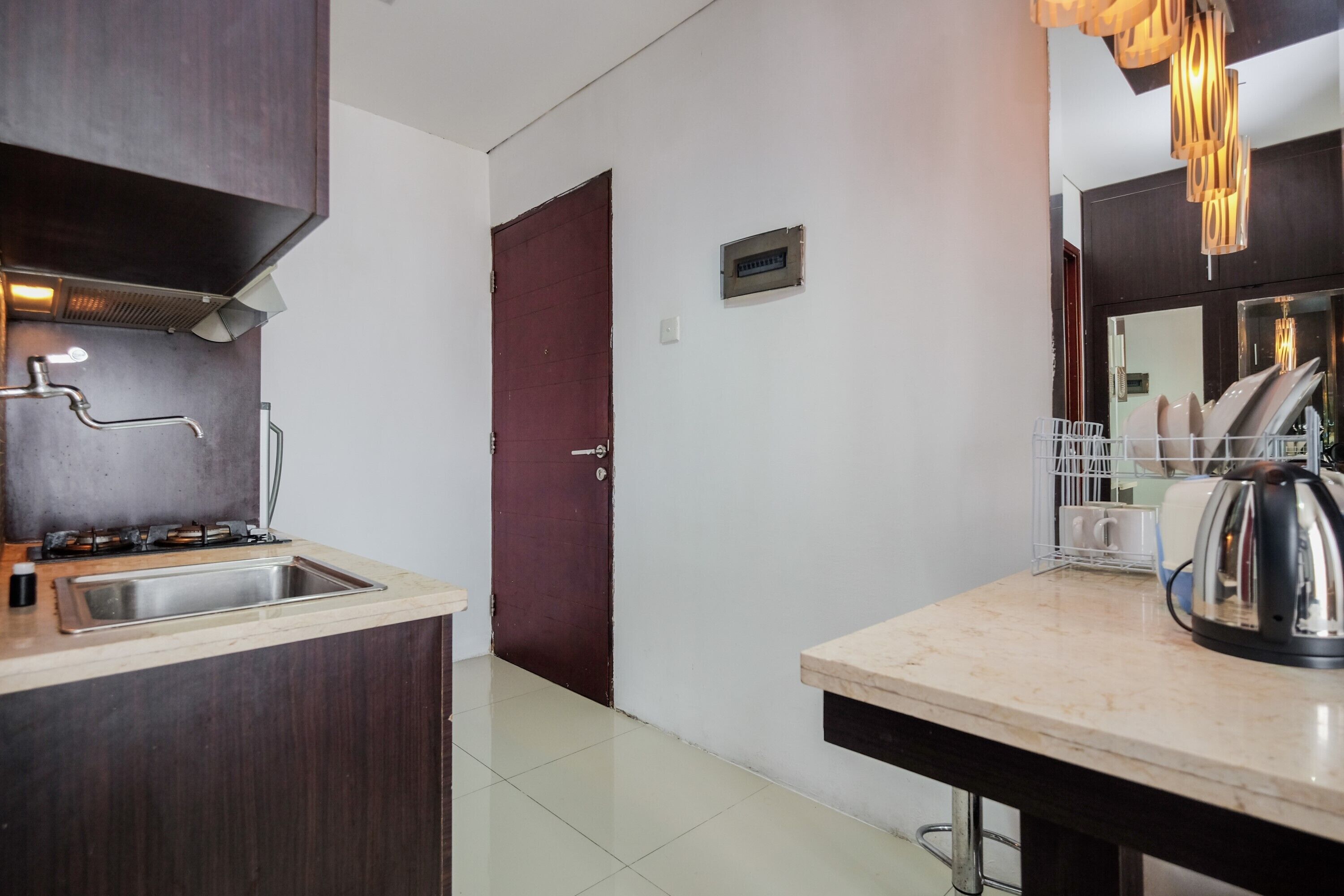 A modern kitchen with a stainless steel sink, a gas stove, and a coffee maker.