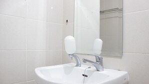 A white bathroom sink with a mirror above it. - Comfy & Scenic Studio Apartment At Parahyangan Residence Near Unpar (Bandung)
