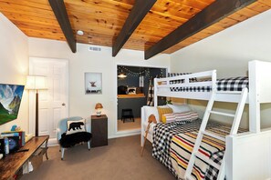 A child's bedroom with bunk beds, a desk with a chair, a lamp, and a framed picture on the wall. - Wonderful Moonridge Location! Mountain Views! Hot Tub! Pool Table! Spacious Deck! (Big Bear Lake)