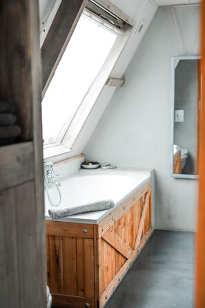 Bathtub, hair dryer, towels, soap