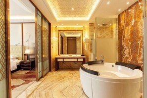 A luxurious bathroom with a large bathtub, a vanity with a mirror, and a shower area. - Tianyuan International Hotel (Kuqa)