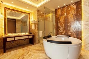 A modern bathroom with a large mirror, a round bathtub, and a vanity with multiple sinks. - Tianyuan International Hotel (Kuqa)
