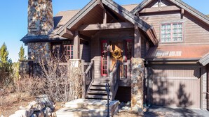 A log cabin with a stone chimney, a front porch, and a garage. - Luxury Private Home In A Great Location. Hot Tub. (Breckenridge)