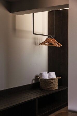 A dark wooden bench with a woven basket containing two towels. - Cook's Club Ialysos Rhodes (Rhodes)