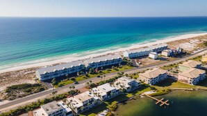 A coastal hotel with multiple buildings, a beach, and a marina. - Contemporary Gulf Front Townhome Just Steps from the Water (Pensacola Beach)