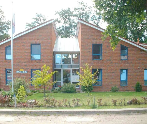 Un edificio de ladrillo de dos pisos con un letrero que dice "HAUS FREYA".