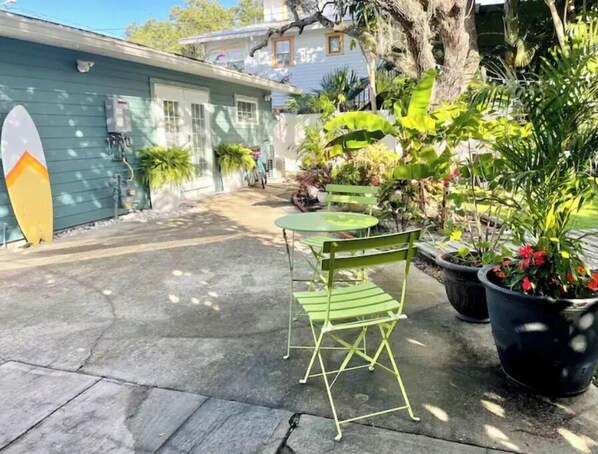 Relax in a tranquil outdoor space surrounded by lush greenery and tropical foliage.