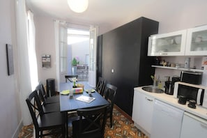A compact kitchen with a dining area, a microwave, and a dishwasher.
