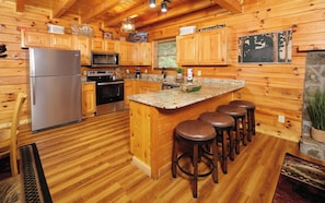 Enjoy cooking in this fully equipped kitchen with a central island and bar stools.