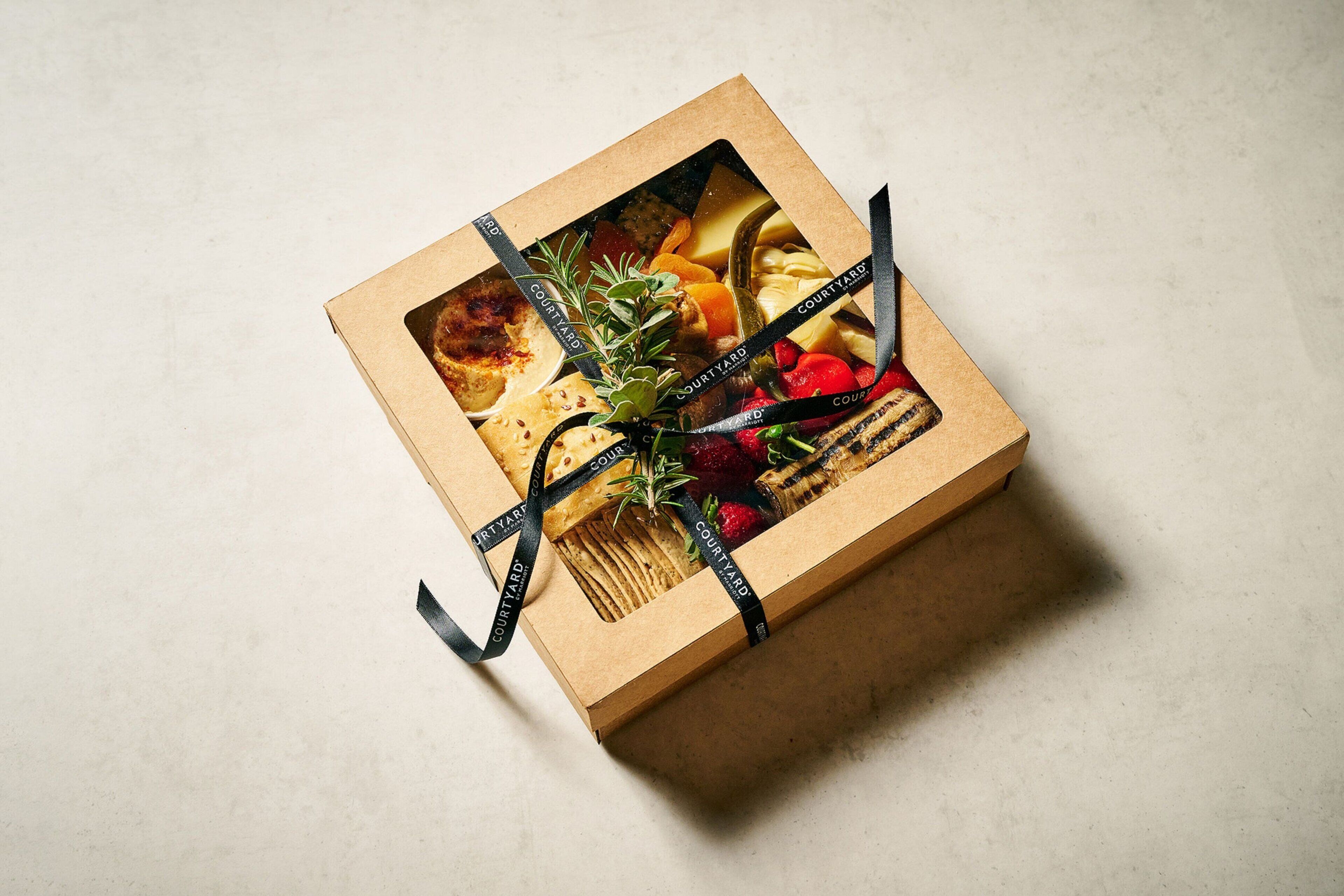 A gift box with a ribbon and a picture of food items.