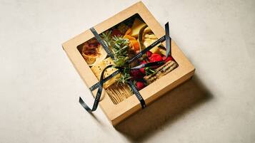 A gift box with a ribbon and a picture of food items.