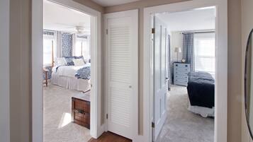 A bedroom with a bed, a dresser, and a nightstand.