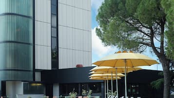 Experience the sleek, contemporary design of Belstay, featuring a spacious pool area with lounge chairs and umbrellas.