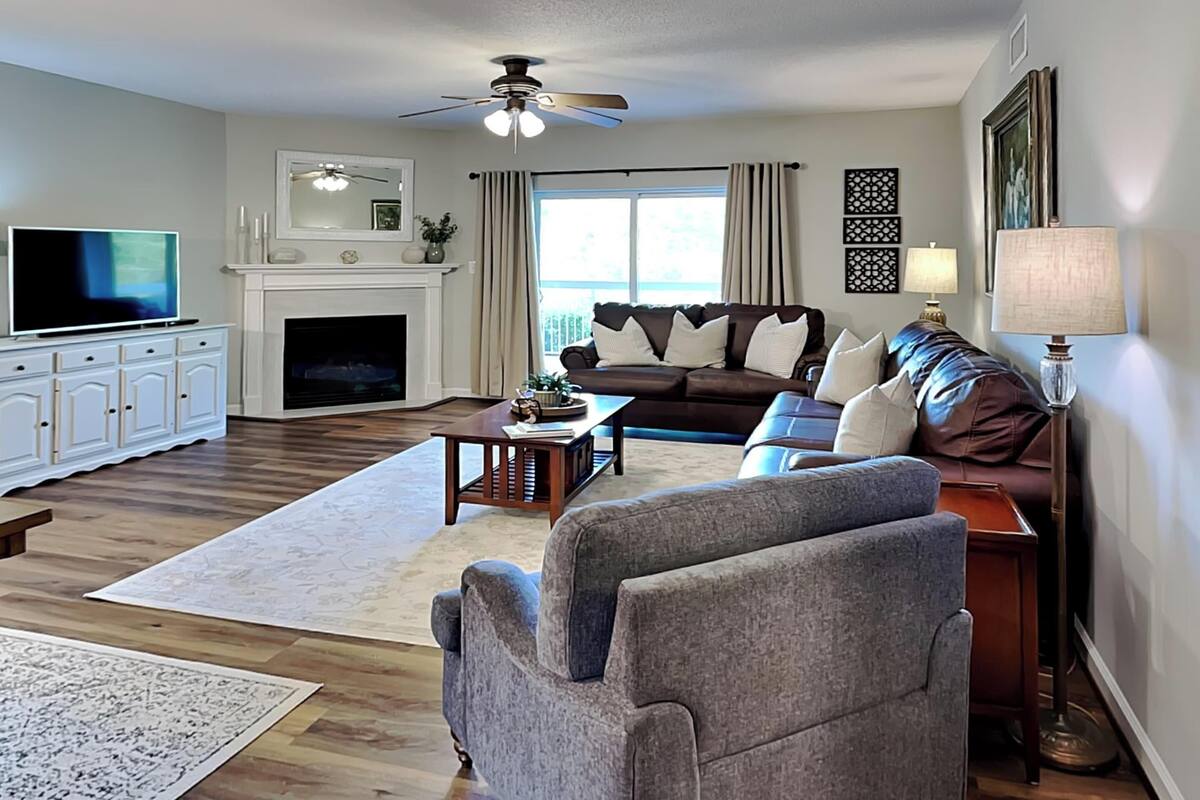 A living room with a fireplace, a television, a sofa, and a coffee table.