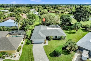 Enjoy a peaceful stay in this single-story house with a well-maintained lawn and shaded outdoor space.