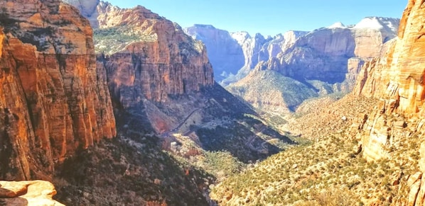 A canyon with steep cliffs and sparse vegetation.