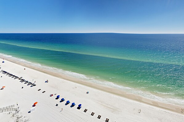 Enjoy a relaxing beachside experience with a clear view of the ocean from our resort's comfortable lounge chairs.