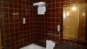 Un baño con bañera, lavabo y espejo.
